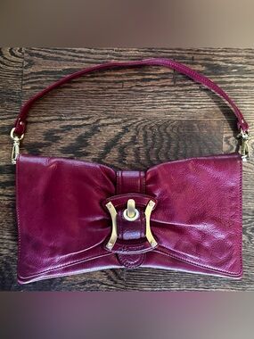 B. Makowsky red leather clutch with gold hardware